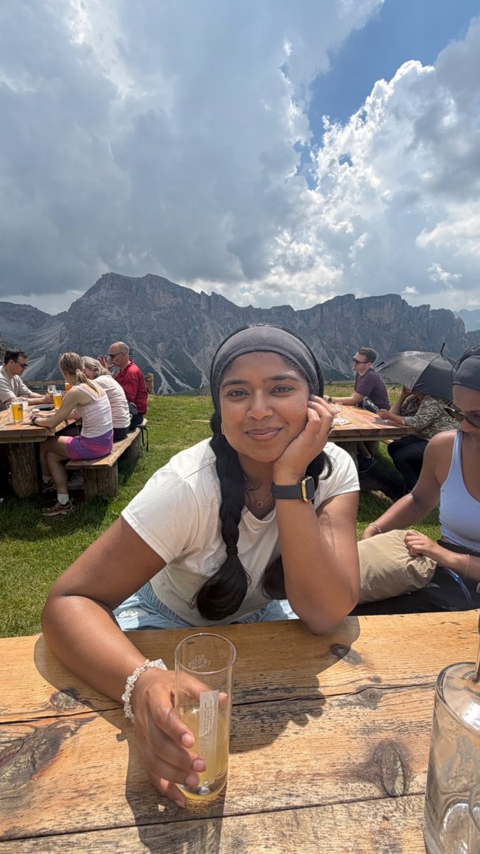 Shruthi relaxing at a refugio table in the Dolomites